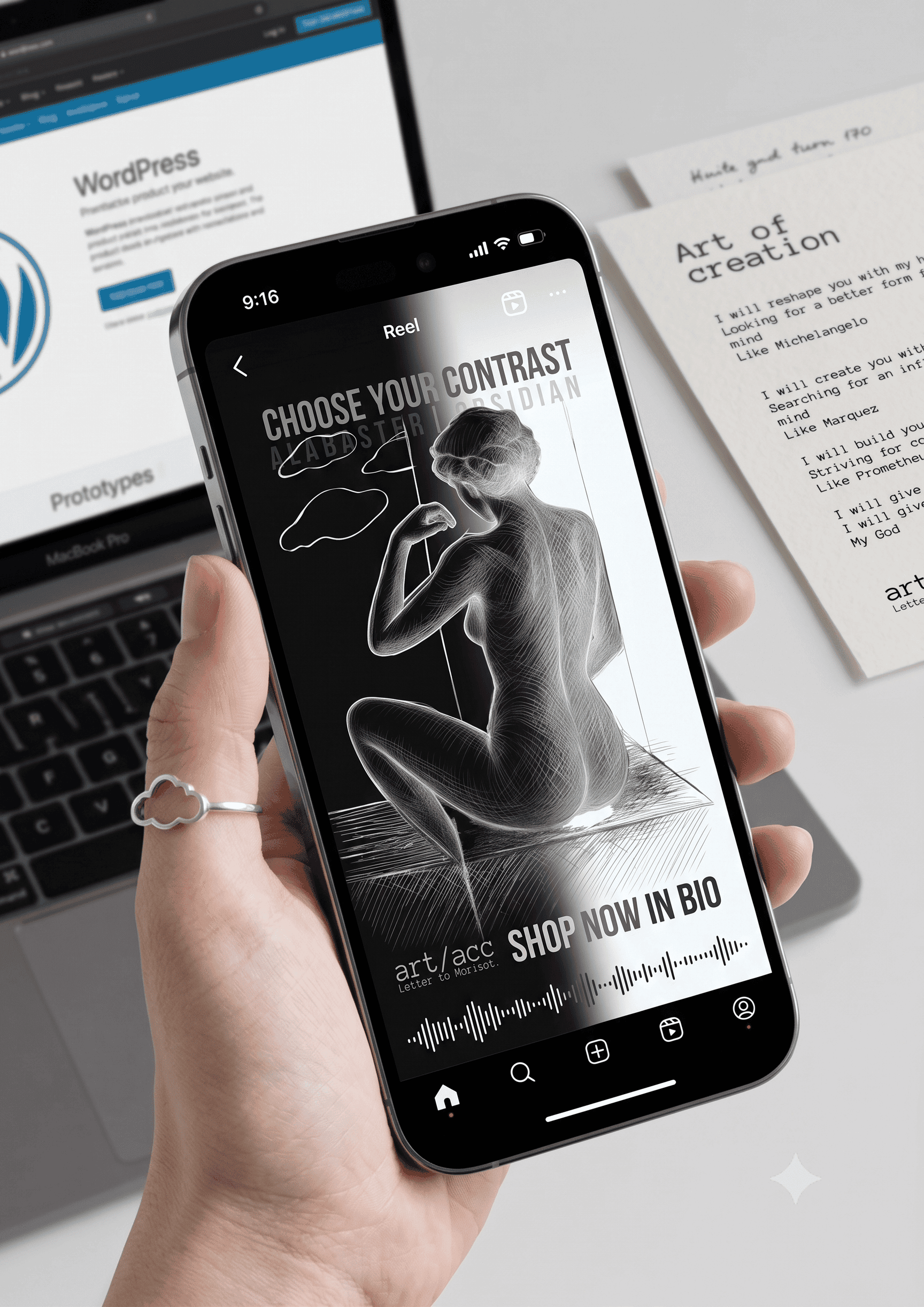 Art accelerationism manifesto print displayed on a mobile phone next to a laptop with WordPress editor